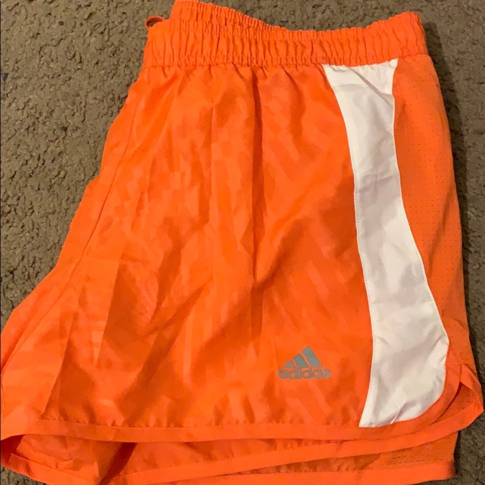 Orange adidas running shorts